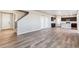 Spacious living area with wood floors and view of the kitchen at 4284 Gozzer Ranch Dr, Elizabeth, CO 80107