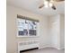 Bedroom with large window, neutral walls, and carpet at 1101 Bellaire St # 108, Denver, CO 80220