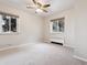 Bright bedroom with ceiling fan and neutral carpeting at 1101 Bellaire St # 108, Denver, CO 80220