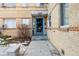 Private entrance with blue door and a stone bench at 1101 Bellaire St # 108, Denver, CO 80220