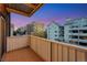 Balcony view of surrounding buildings on a property with light metal railings and brown deck flooring at 4110 Hale Pkwy Pkwy # 4J, Denver, CO 80220
