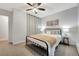 Bedroom with neutral décor, ceiling fan and patterned gray carpet with a full-sized bed and an end table at 4110 Hale Pkwy Pkwy # 4J, Denver, CO 80220