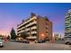 Exterior of brick apartment building with balconies and on-street parking in a well-maintained landscape at 4110 Hale Pkwy Pkwy # 4J, Denver, CO 80220