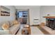 Well-lit living room featuring a fireplace and access to a balcony at 4110 Hale Pkwy Pkwy # 4J, Denver, CO 80220