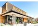 Postino restaurant exterior featuring neon signage, outdoor seating, and modern architectural design at 4110 Hale Pkwy Pkwy # 4J, Denver, CO 80220