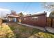 Exterior of property with partial view of backyard grass and wooden fence at 625 Ammons St, Lakewood, CO 80214