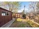View of a well kept backyard with two outdoor storage sheds at 625 Ammons St, Lakewood, CO 80214