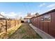 Well kept backyard with small patch of grass and wooden fence on a sunny day at 625 Ammons St, Lakewood, CO 80214