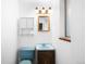 Vintage bathroom featuring blue fixtures, beadboard paneling, and ample lighting at 625 Ammons St, Lakewood, CO 80214