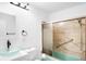 Bright bathroom features a vessel sink, updated fixtures, and a shower with sliding glass doors at 625 Ammons St, Lakewood, CO 80214