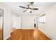 Bright bedroom offers hardwood floors, a lighted ceiling fan, and multiple doorways at 625 Ammons St, Lakewood, CO 80214