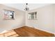 Bright bedroom featuring hardwood floors, two windows and a modern chandelier at 625 Ammons St, Lakewood, CO 80214
