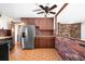 Functional kitchen with wood cabinets, stainless steel appliances, and a cozy adjacent dining space at 625 Ammons St, Lakewood, CO 80214