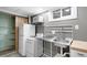 Basement kitchenette with stainless steel sink and retro appliances at 625 Ammons St, Lakewood, CO 80214