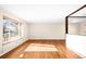 Open-concept living room with hardwood floors, a large window, and abundant natural light at 625 Ammons St, Lakewood, CO 80214