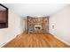 Bright living room featuring hardwood floors, a unique stone fireplace, and ample natural light at 625 Ammons St, Lakewood, CO 80214