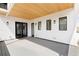 Outdoor deck with a wooden ceiling and white siding, featuring sliding glass doors at 8260 E 36Th Ave # 29, Denver, CO 80238