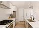 Modern kitchen with stainless steel appliances, white cabinets, and stylish backsplash at 8260 E 36Th Ave # 29, Denver, CO 80238