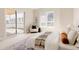 Bright main bedroom with stylish decor, large window, and sliding glass door to outdoor deck at 8260 E 36Th Ave # 29, Denver, CO 80238