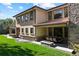 Expansive backyard with a patio, fire pit, outdoor dining area, and lush green lawn, perfect for entertaining at 2 Viking Dr, Englewood, CO 80113