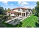 Private backyard with swimming pool, hot tub, manicured lawn, and patio seating area at 2 Viking Dr, Englewood, CO 80113