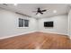 Bright bedroom with hardwood floors, crown molding, a ceiling fan, and a mounted television at 2 Viking Dr, Englewood, CO 80113
