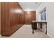 Large walk-in closet with custom wooden cabinetry and an adjacent desk area for added functionality at 2 Viking Dr, Englewood, CO 80113