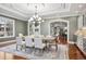 Formal dining room with chandelier lighting, elegant décor, and large windows at 2 Viking Dr, Englewood, CO 80113