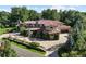 Beautifully landscaped home featuring a circular driveway, mature trees and attached three-car garage at 2 Viking Dr, Englewood, CO 80113