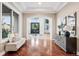 Grand foyer with hardwood floors, arched doorways, and natural light creates a welcoming entrance at 2 Viking Dr, Englewood, CO 80113