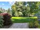 Expansive front lawn with meticulously maintained landscaping and mature trees at 2 Viking Dr, Englewood, CO 80113