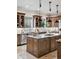 Well-equipped kitchen island, stainless steel appliances, and natural light creates an ideal cooking space at 2 Viking Dr, Englewood, CO 80113