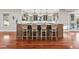 Spacious kitchen features a large island with seating and hardwood flooring throughout at 2 Viking Dr, Englewood, CO 80113