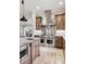 Chef's kitchen features a stainless range, tile backsplash, and granite countertops at 2 Viking Dr, Englewood, CO 80113