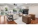 Inviting living room features a fireplace, hardwood floors, and neutral furnishings with views of the backyard at 2 Viking Dr, Englewood, CO 80113