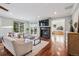 Bright living room featuring a fireplace, wood floors, and large windows offering scenic views at 2 Viking Dr, Englewood, CO 80113