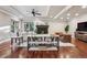 Cozy living room with fireplace, hardwood floors, recessed lighting, and neutral decor at 2 Viking Dr, Englewood, CO 80113