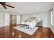 Large main bedroom with hardwood floors, bench and lots of natural light from the many windows at 2 Viking Dr, Englewood, CO 80113