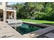 Beautiful backyard with a sparkling pool surrounded by manicured landscaping and a stone fire pit at 2 Viking Dr, Englewood, CO 80113