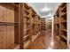 Extensive walk-in closet with custom wooden shelving and ample storage space at 2 Viking Dr, Englewood, CO 80113