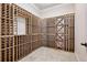 Custom-built wine cellar with wooden racking, offering ample storage in a climate-controlled environment at 2 Viking Dr, Englewood, CO 80113