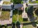 Aerial view shows a well-maintained lawn, detached garage, and tidy landscaping at 3018 S Depew St, Denver, CO 80227