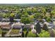 Aerial neighborhood view shows mature trees surrounding homes with tidy lawns at 3018 S Depew St, Denver, CO 80227