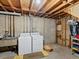 Unfinished basement laundry area with washer, dryer, and utility sink at 3018 S Depew St, Denver, CO 80227