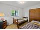 Bedroom with two twin beds, wood frames, and natural light from the window at 3018 S Depew St, Denver, CO 80227