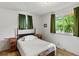 Bright bedroom with natural light, neutral walls, and vintage-style furnishings at 3018 S Depew St, Denver, CO 80227