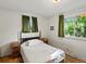 Bright bedroom with hardwood floors, large windows, and vintage dressers at 3018 S Depew St, Denver, CO 80227