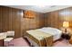 Cozy bedroom with wood paneling and a comfortable bed at 3018 S Depew St, Denver, CO 80227