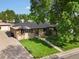 Single-story brick home with a large front yard and mature shade tree at 3018 S Depew St, Denver, CO 80227