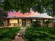 Charming single-story home with a well-kept lawn and mature tree, highlighted by a vibrant sunset at 3018 S Depew St, Denver, CO 80227